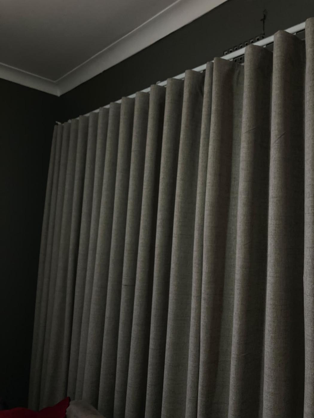 Botanical print tailored roman blind fitted across a bay window, paired with a green side curtain