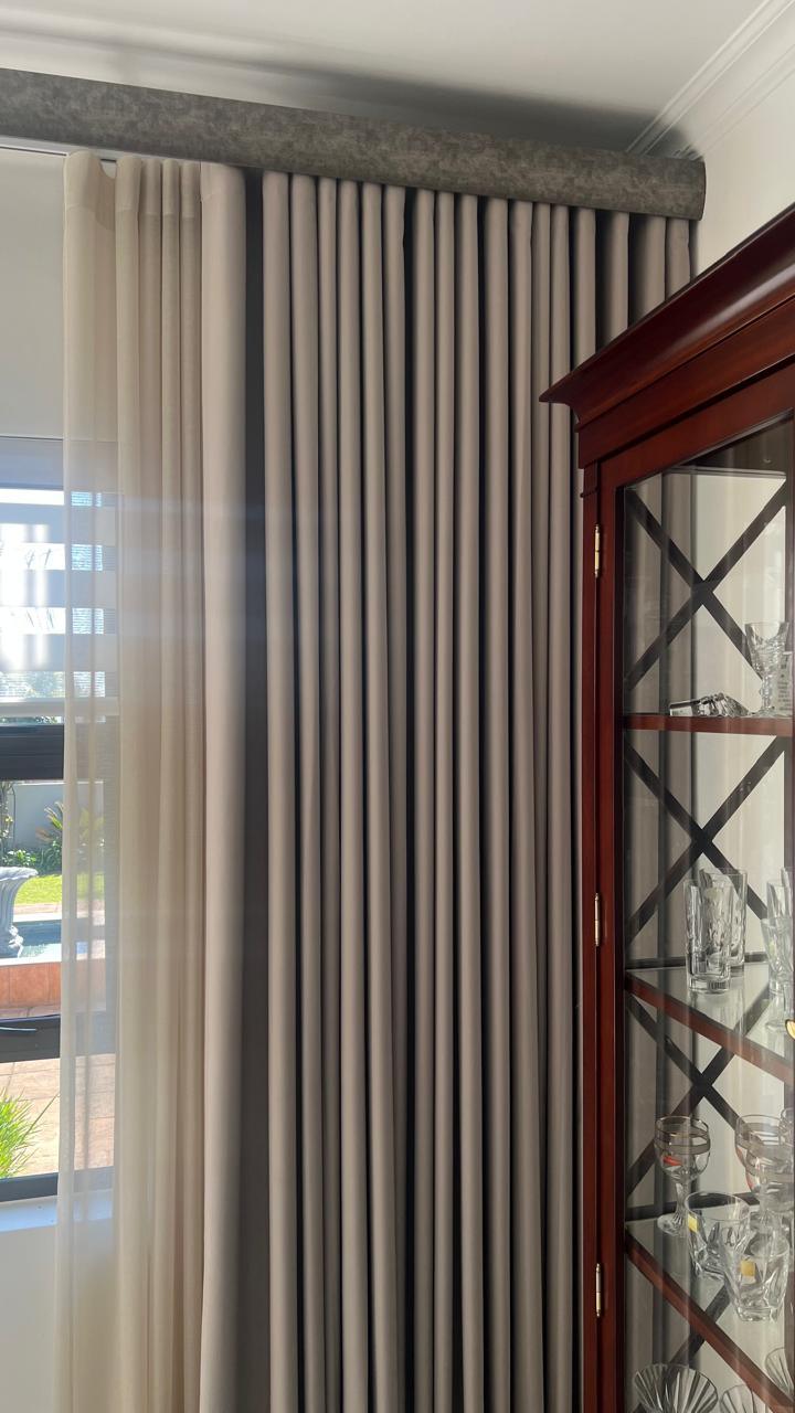 Wave-fold curtain detail beside a display cabinet